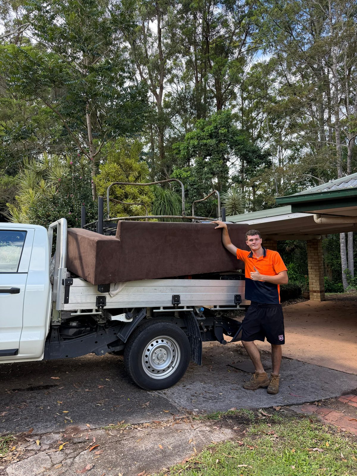 Pickup Pals removalist beside a couch loaded on the ute