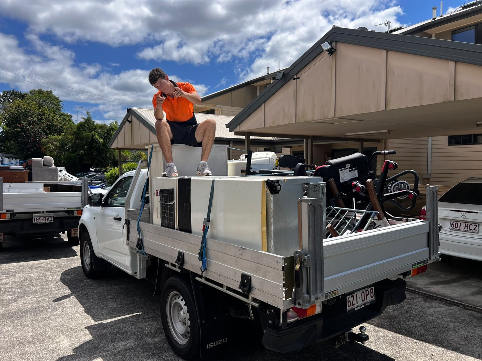 Pickup Pals crew member on top of a full ute tray of household items